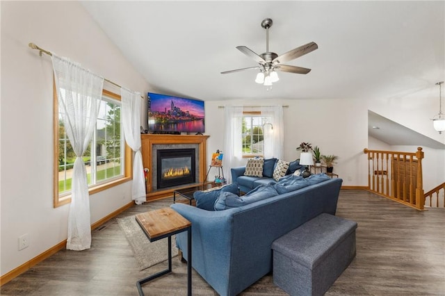 819 Fairway Cir, Black River Falls, WI 54615 - living room with wood finished floors, ceiling fan, lofted ceiling, a glass covered fireplace, and baseboards
