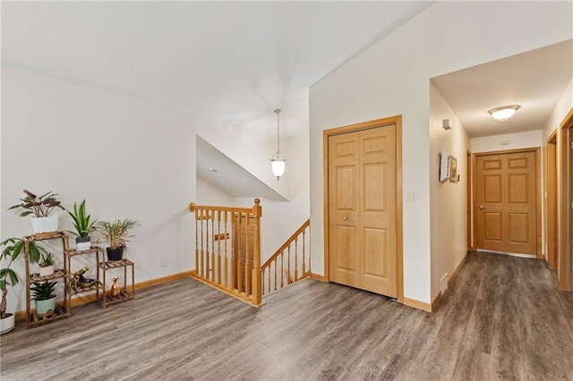 819 Fairway Cir, Black River Falls, WI 54615 - corridor with an upstairs landing, wood finished floors, and baseboards