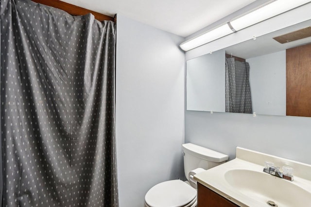 4912 Schofield St, Monona, WI 53716 - full bath featuring vanity, toilet, and a shower with shower curtain