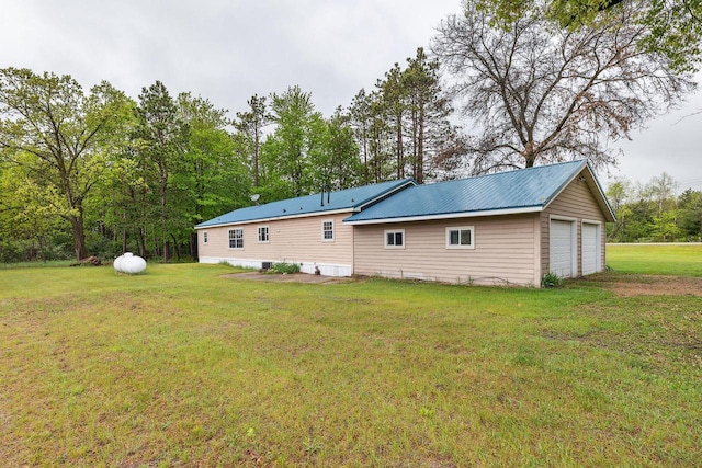 11253 State Highway 71, Sparta, WI 54656 - rear view of house featuring a lawn, a detached garage, and metal roof
