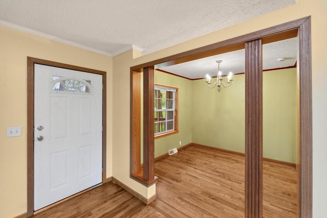 11253 State Highway 71, Sparta, WI 54656 - entryway featuring light wood-style floors, healthy amount of natural light, crown molding, a chandelier, and baseboards