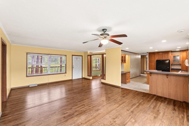 11253 State Highway 71, Sparta, WI 54656 - unfurnished living room with light wood-style floors, ceiling fan, ornamental molding, recessed lighting, and baseboards