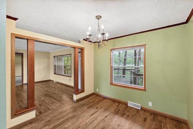 11253 State Highway 71, Sparta, WI 54656 - unfurnished room with a chandelier, wood finished floors, healthy amount of natural light, a textured ceiling, and baseboards