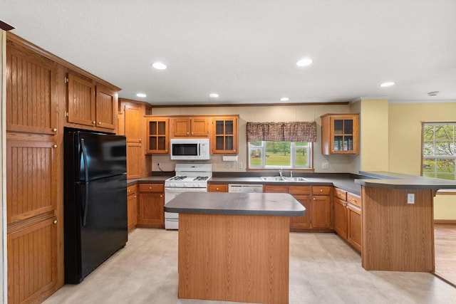 11253 State Highway 71, Sparta, WI 54656 - kitchen with white appliances, a peninsula, a sink, dark countertops, and recessed lighting