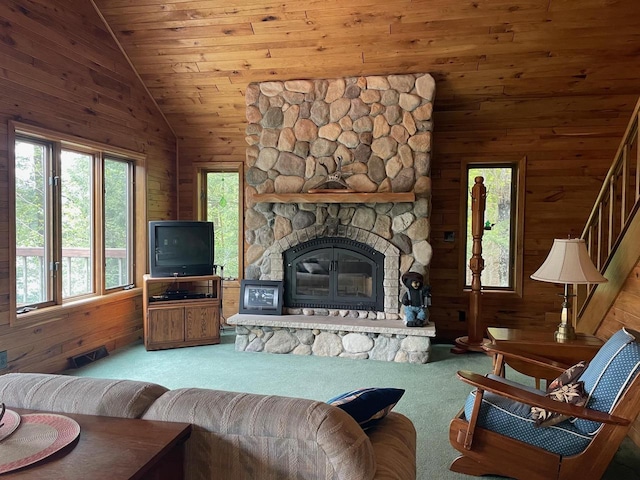 17235 Little Archibald Rd, Townsend, WI 54175 - carpeted living room with wooden walls, vaulted ceiling, a fireplace, and stairway