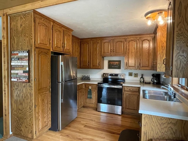 17235 Little Archibald Rd, Townsend, WI 54175 - kitchen featuring stainless steel appliances, a sink, and brown cabinets