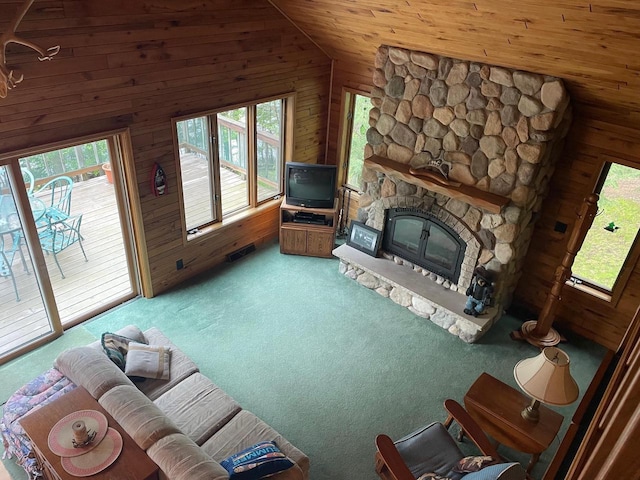 17235 Little Archibald Rd, Townsend, WI 54175 - living room with carpet floors, wooden walls, lofted ceiling, a fireplace, and wood ceiling