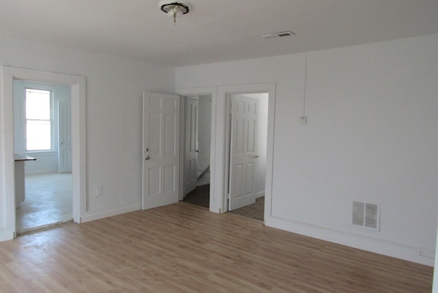 1817 N 22nd St Unit 1819, Milwaukee, WI 53205 - unfurnished room with light wood-style floors and baseboards