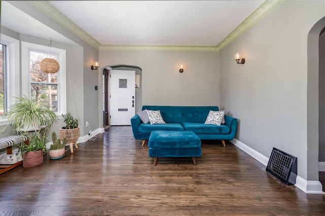 4892 N Mohawk Ave, Glendale, WI 53217 - living room featuring arched walkways, wood finished floors, baseboards, and crown molding