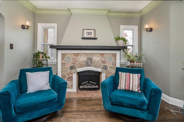 4892 N Mohawk Ave, Glendale, WI 53217 - living area featuring a fireplace, healthy amount of natural light, wood finished floors, crown molding, and arched walkways
