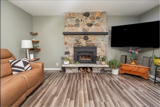4892 N Mohawk Ave, Glendale, WI 53217 - living room with wood finished floors, baseboards, and a stone fireplace