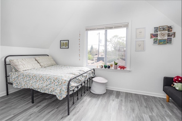 4892 N Mohawk Ave, Glendale, WI 53217 - bedroom featuring vaulted ceiling, wood finished floors, and baseboards