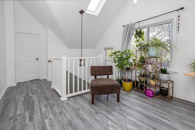 4892 N Mohawk Ave, Glendale, WI 53217 - living area with a skylight, wood finished floors, lofted ceiling, and baseboards