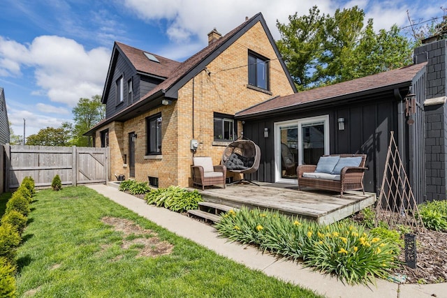 4892 N Mohawk Ave, Glendale, WI 53217 - back of property with a wooden deck, board and batten siding, a gate, brick siding, and a chimney