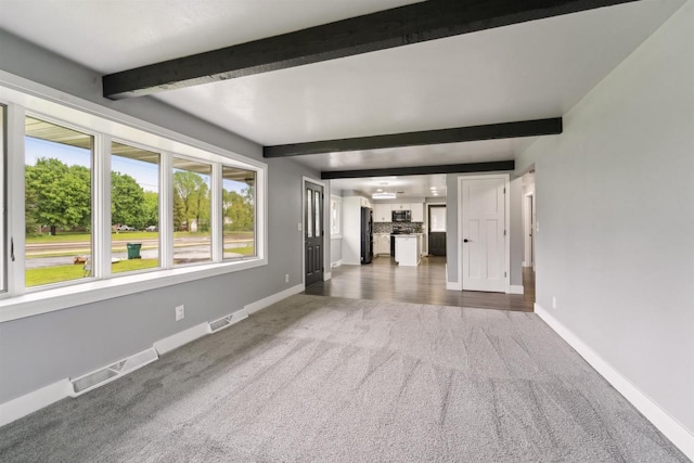 1523 N Lynndale Dr, Appleton, WI 54914 - unfurnished living room featuring carpet, beamed ceiling, and baseboards