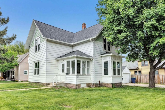 60 Brix St, Clintonville, WI 54929 - back of property with a chimney, a shingled roof, an outbuilding, a garage, and entry steps