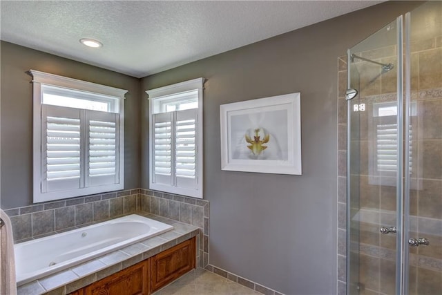 1816 186th St, Chippewa Falls, WI 54729 - full bathroom featuring a jetted tub, a shower stall, a textured ceiling, and tile patterned floors