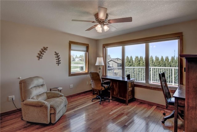 1816 186th St, Chippewa Falls, WI 54729 - home office with hardwood / wood-style floors, a ceiling fan, baseboards, and a textured ceiling
