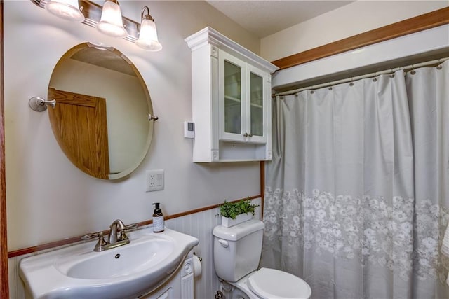 1816 186th St, Chippewa Falls, WI 54729 - bathroom with toilet, vanity, a wainscoted wall, and curtained shower