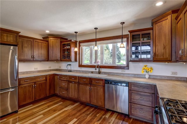 1816 186th St, Chippewa Falls, WI 54729 - kitchen featuring appliances with stainless steel finishes, a sink, recessed lighting, decorative light fixtures, and glass insert cabinets
