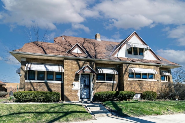 4101 N 14th St, Milwaukee, WI 53209 - view of front of home with a front lawn, brick siding, and a chimney