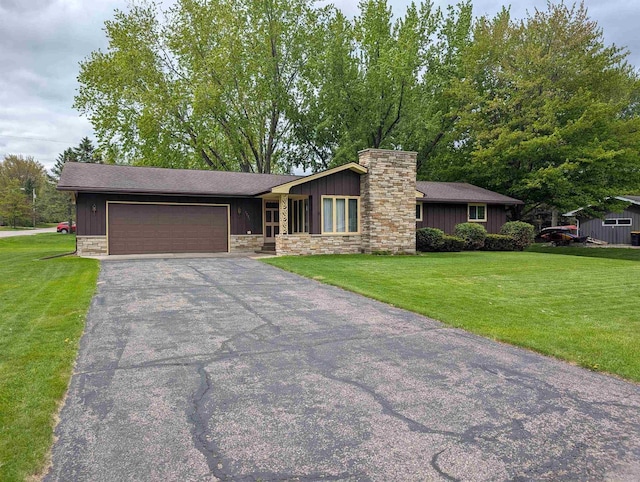 1741 Heuss Ave, Weston, WI 54476 - view of front of house with stone siding, asphalt driveway, a garage, and a front lawn