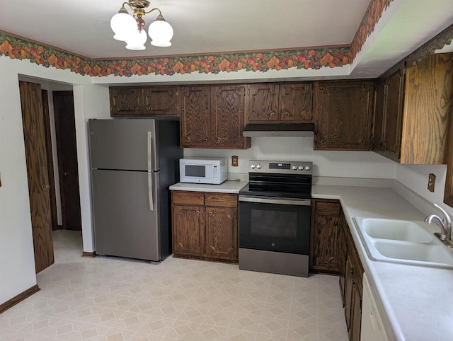 1741 Heuss Ave, Weston, WI 54476 - kitchen with stainless steel appliances, under cabinet range hood, a sink, and light countertops