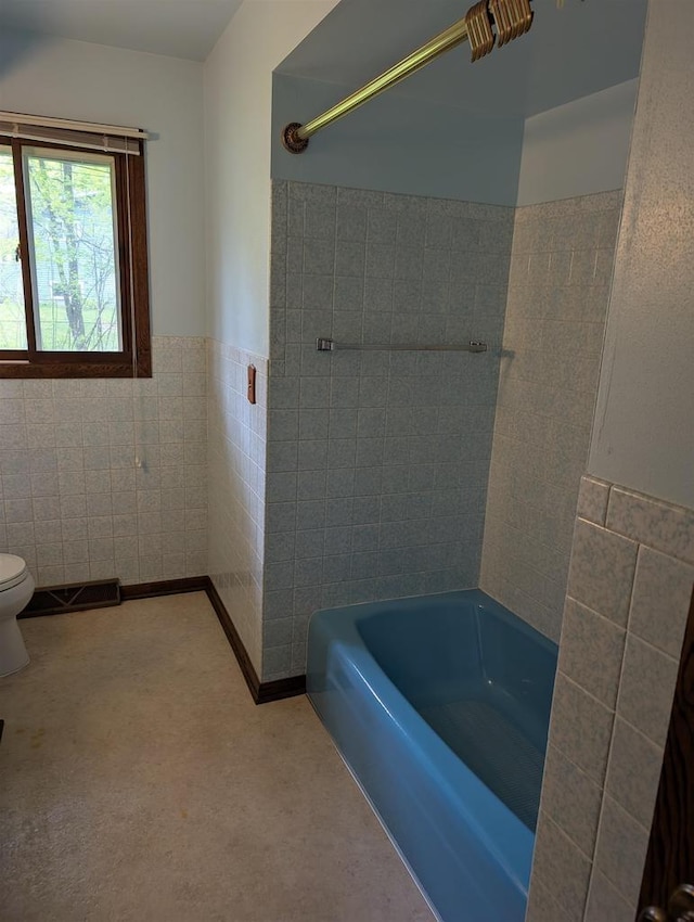 1741 Heuss Ave, Weston, WI 54476 - bathroom featuring tile walls, toilet, a wainscoted wall, and shower / washtub combination