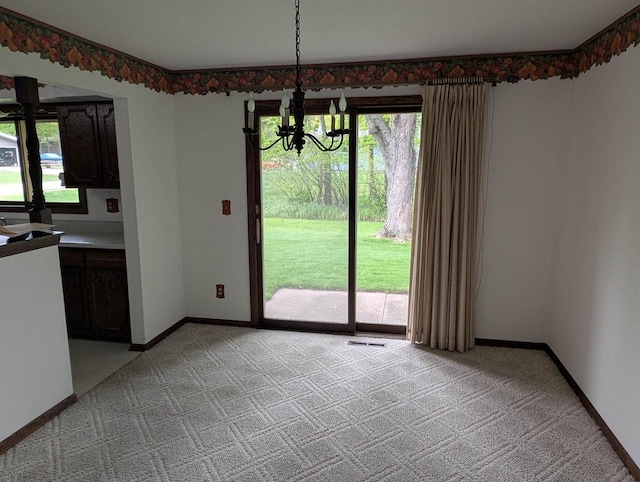 1741 Heuss Ave, Weston, WI 54476 - unfurnished dining area featuring light colored carpet, a chandelier, plenty of natural light, and baseboards