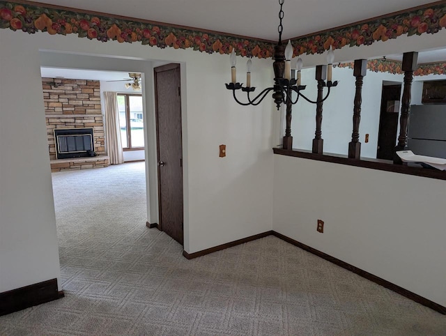 1741 Heuss Ave, Weston, WI 54476 - unfurnished dining area with carpet flooring, a stone fireplace, baseboards, and a ceiling fan