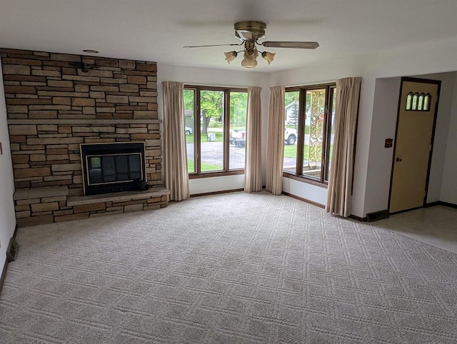 1741 Heuss Ave, Weston, WI 54476 - unfurnished living room with a ceiling fan, a stone fireplace, carpet flooring, and baseboards