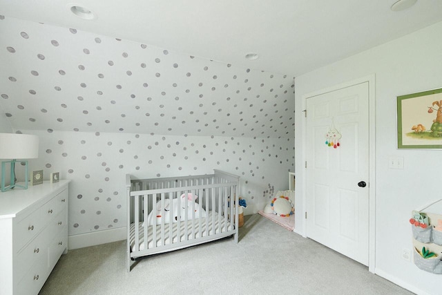 1605 E Webster Pl, Milwaukee, WI 53211 - bedroom with light carpet, wallpapered walls, a nursery area, and baseboards