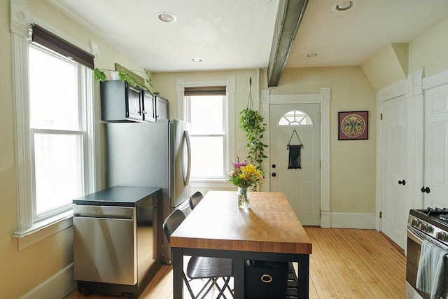 1605 E Webster Pl, Milwaukee, WI 53211 - kitchen with light wood-style floors, appliances with stainless steel finishes, baseboards, beamed ceiling, and recessed lighting