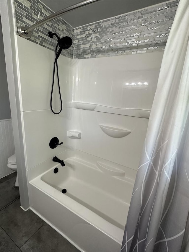 174 Mckinley Ave, Clintonville, WI 54929 - bathroom with toilet, shower / tub combo with curtain, tile patterned flooring, and a wainscoted wall