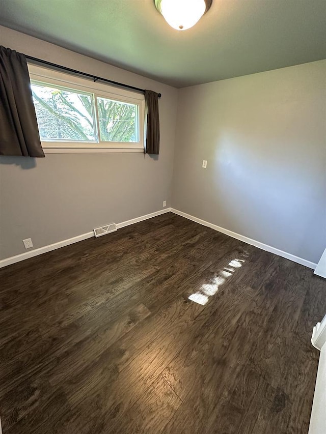 174 Mckinley Ave, Clintonville, WI 54929 - spare room featuring dark wood finished floors and baseboards