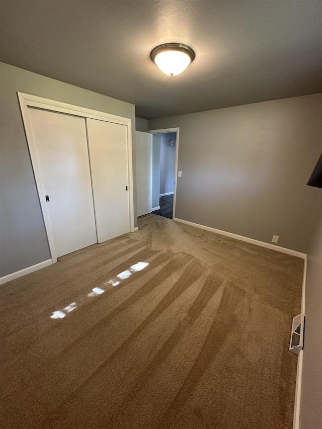 174 Mckinley Ave, Clintonville, WI 54929 - unfurnished bedroom featuring a closet, carpet floors, and baseboards