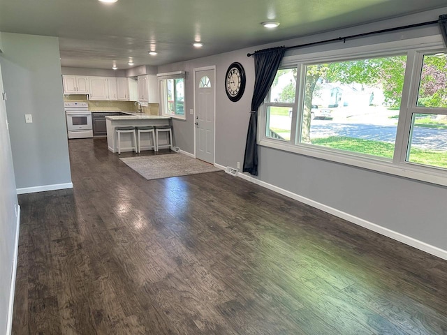 174 Mckinley Ave, Clintonville, WI 54929 - kitchen with white electric stove, dark wood-style flooring, a sink, baseboards, and recessed lighting