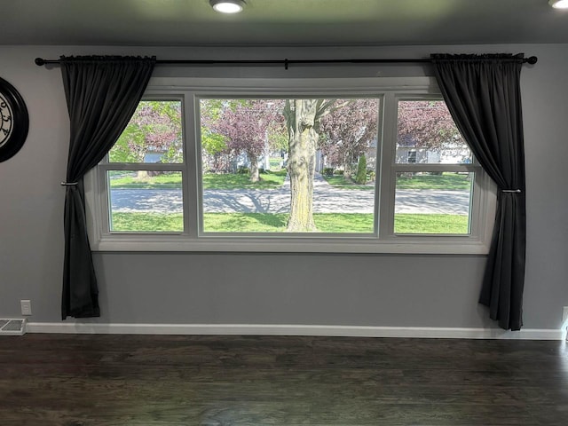 174 Mckinley Ave, Clintonville, WI 54929 - unfurnished dining area with baseboards and dark wood-style floors