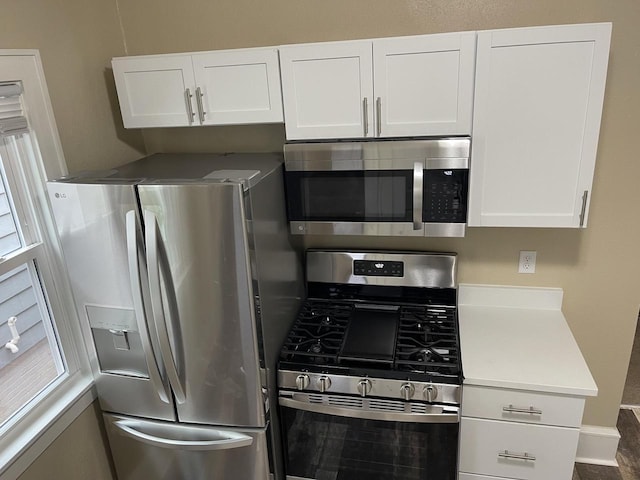 3122 W Madison St, Milwaukee, WI 53215 - kitchen featuring appliances with stainless steel finishes, white cabinets, and light countertops