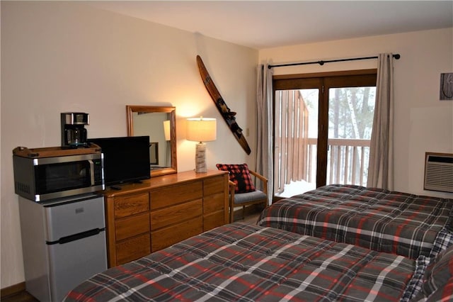 15326 W Birch Point Rd, Hayward, WI 54843 - bedroom featuring refrigerator, access to outside, and an AC wall unit