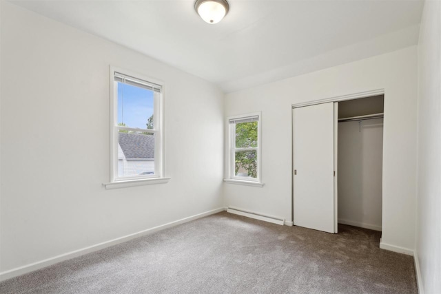815 Madison St, Little Chute, WI 54140 - unfurnished bedroom with baseboard heating, carpet floors, a closet, and baseboards