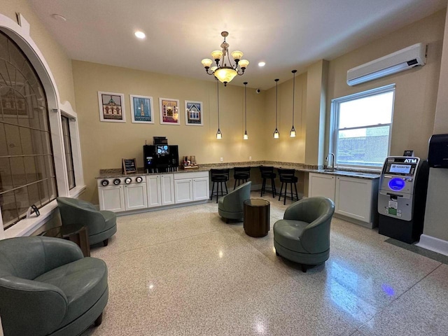 1028 E Juneau Ave Unit 204-206, Milwaukee, WI 53202 - living room featuring a wall mounted air conditioner, a chandelier, recessed lighting, and baseboards
