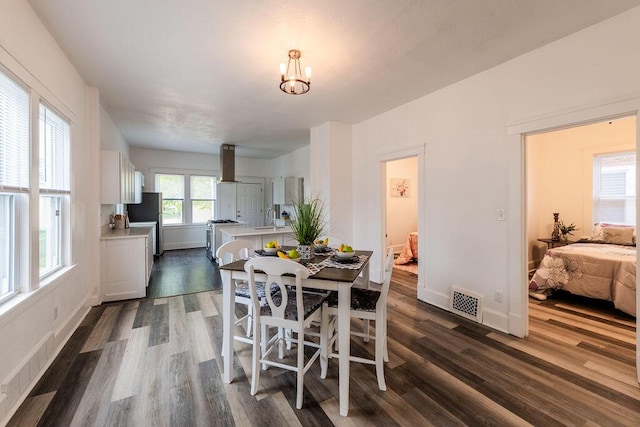 1516 Blake Ave, Racine, WI 53404 - dining space with dark wood-style flooring, baseboards, and a chandelier