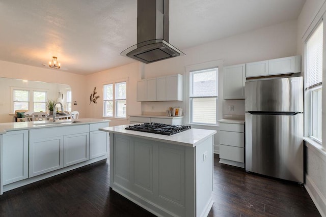 1516 Blake Ave, Racine, WI 53404 - kitchen with freestanding refrigerator, black gas stovetop, wall chimney range hood, a center island, and a sink