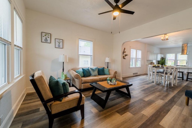 1516 Blake Ave, Racine, WI 53404 - living room with dark wood-style flooring, baseboards, ceiling fan, and arched walkways