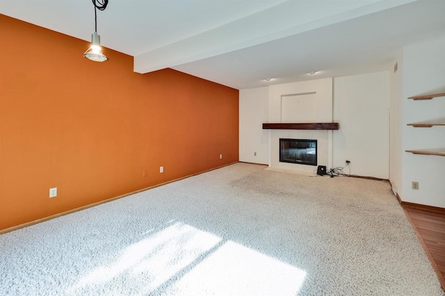 69 Ponwood Cir, Madison, WI 53717 - unfurnished living room featuring a fireplace with flush hearth, beamed ceiling, baseboards, and carpet floors