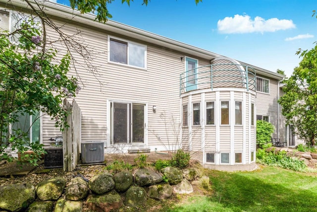 69 Ponwood Cir, Madison, WI 53717 - back of property featuring a balcony, cooling unit, and a lawn