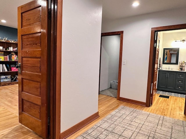 11691 County Road P, Bagley, WI 53801 - corridor featuring light wood-type flooring, a sink, recessed lighting, and baseboards