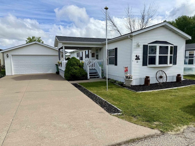 33150 Donna Dr, Prairie Du Chien, WI 53821 - view of front facade with an outbuilding, a front yard, a garage, and a porch