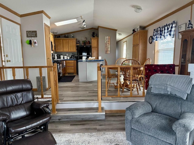 33150 Donna Dr, Prairie Du Chien, WI 53821 - living area featuring ornamental molding, vaulted ceiling, light wood finished floors, and a skylight